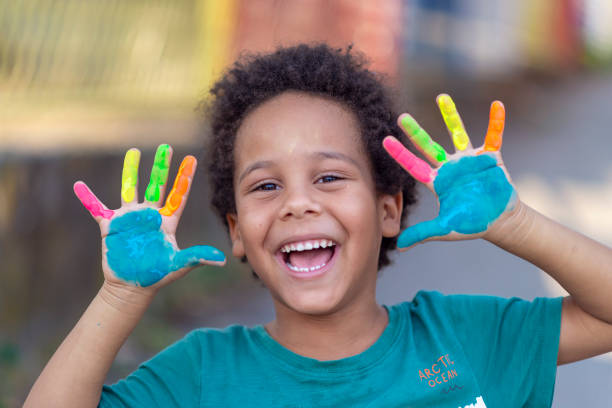 istock beautiful happy boy with painted hands 1207261173