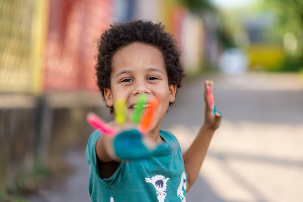 istock beautiful happy boy with painted hands 1207261297