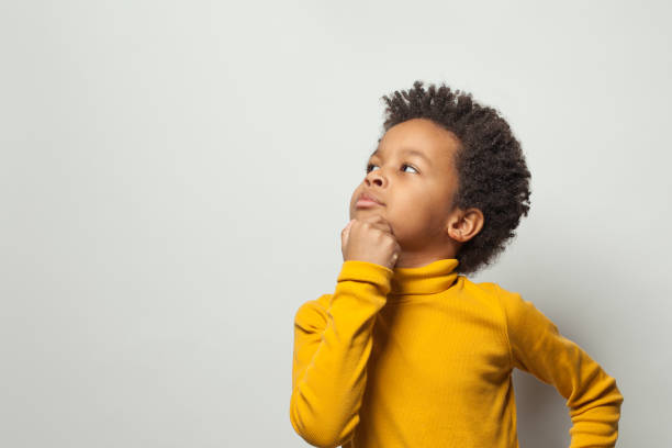 istock Smart schoolboy black kid boy thinking on white background 1207261589