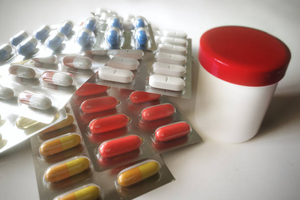 istock Antibiotic tablets with a medicine dose on a white table - 3D Rendering 1207261700