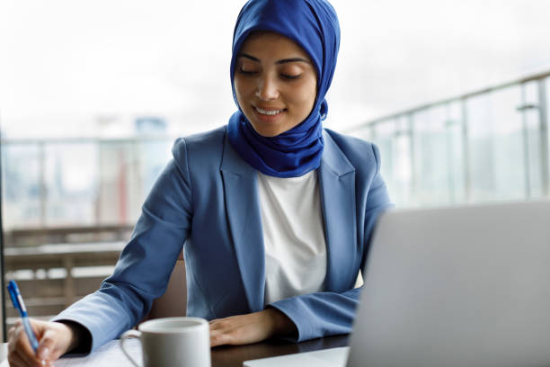 istock Young woman working at a cafe 1207261850