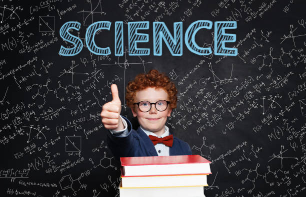 istock Successful smart kid wearing glasses and student uniform on science background 1207263556