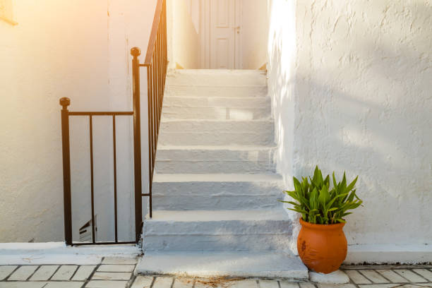Mediterranean white street with vase and plant.