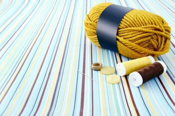 Embroidery accessories for a variety of colors, such as yarn, needle and buttons brought together for workshop class.