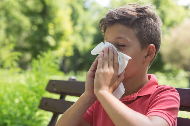 istock Boy with a flue wiping nose 1207266042