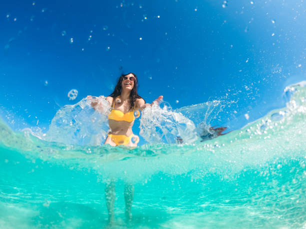 istock Woman in sea sprinkle camera 1207266052