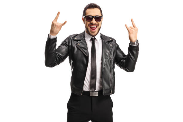 istock Cool young man in a leather jacket gesturing rock and roll symbol 1207267054