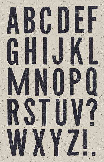 Vector sans serif vintage alphabet with halftone texture on a grey textured background