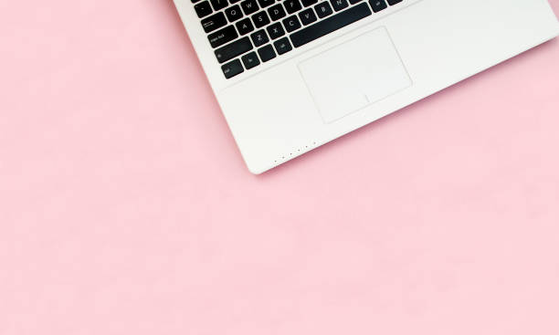 istock Black-white laptop keyboard on a pink background. Copy space. Top view. Computer work. Flat lay 1207271194