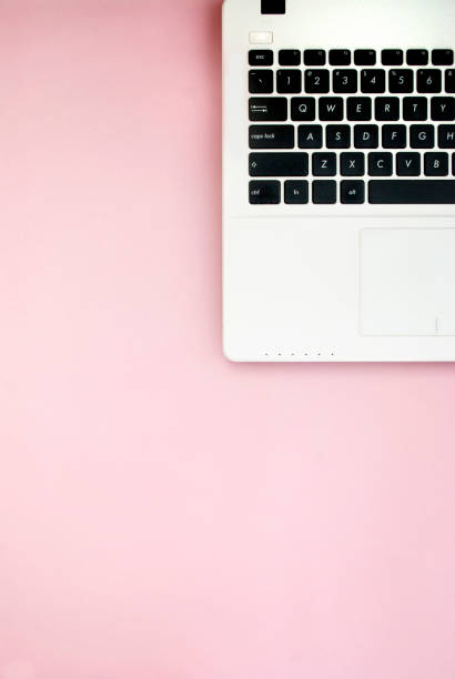 istock Black-white laptop keyboard on a pink background. Copy space. Top view. Computer work. Flat lay 1207271204