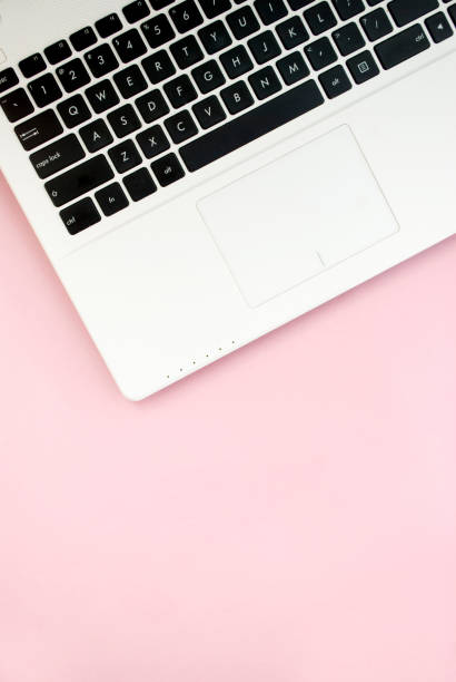 istock Black-white laptop keyboard on a pink background. Copy space. Top view. Computer work. Flat lay 1207271206