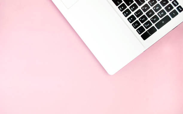 istock Black-white laptop keyboard on a pink background. Copy space. Top view. Computer work. Flat lay 1207271207