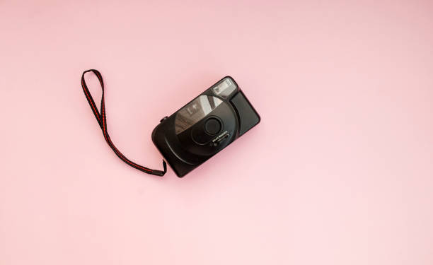 istock Black film camera on a pink background. Flat lay. Copy space. Top view 1207271287