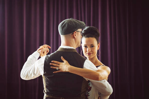 istock Dancing couple in the light dance hall 1207271342