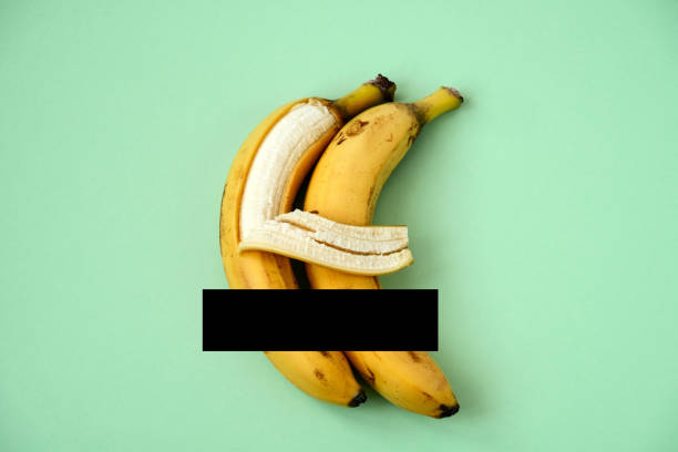 one banana hugs another with its peel - sexual issues imagens e fotografias de stock