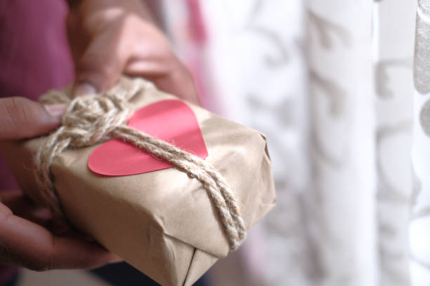 istock Close up of man hand holding gift box 1207271678