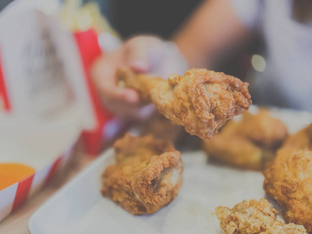 istock Woman hand choose fried chicken 1207271907