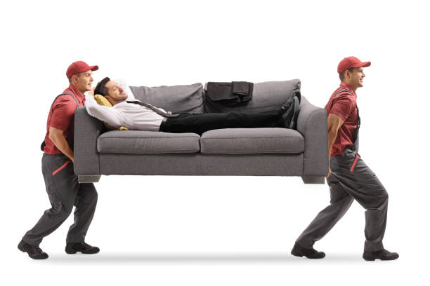 istock Workers carrying a sofa and a businessman sleeping 1207272562