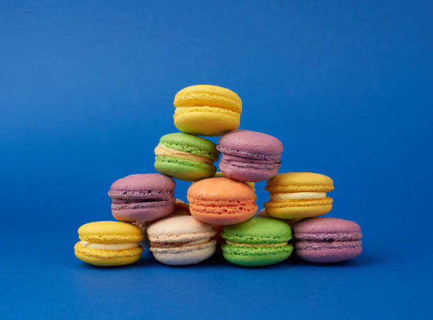 istock stack of multi-colored round baked macarons cakes on a dark blue background 1207272879