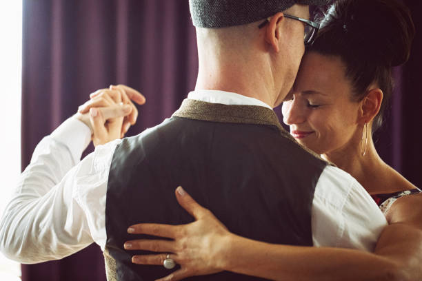 istock Dancing couple in the light dance hall 1207272927