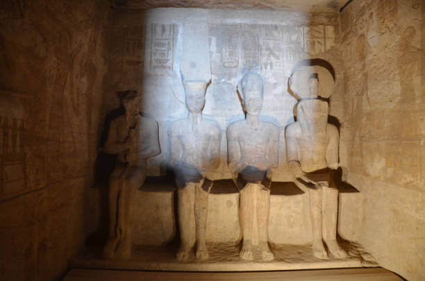 The sunlight on the Abu Simbel statues. The light spear through the darkness, illuminating the statues carved inside Abu Simbel. Sun Festival is one of the annual attraction. temple of luxor hypostyle hall stock pictures, royalty-free photos & images