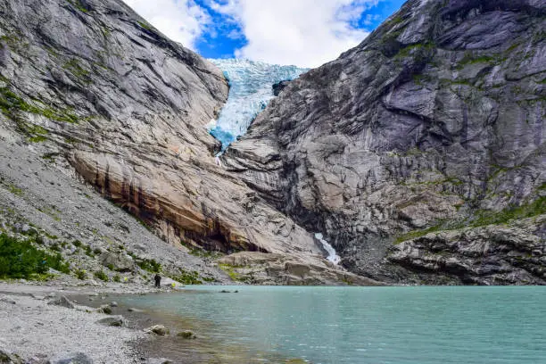 The Brikdalsbreen glacier, which is the sleeve of the large Jostedalsbreen glacier in Norway. The melting glacier forms the Briksdalsbrevatnet lake with clear water.