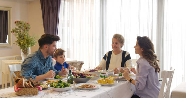 Multi-generation family having a vegan dinner Multi-generation family having a vegan dinner. turkish culture stock pictures, royalty-free photos & images