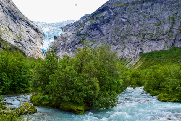 istock The Brikdalsbreen glacier in Norway. The lake with clear water. 1207277418