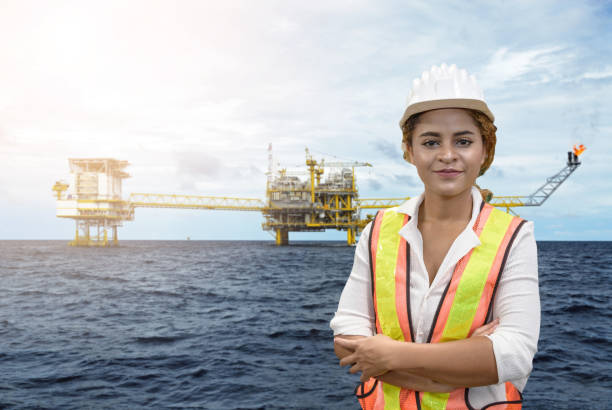 istock mixed race woman engineer staff worker and offshore rig background concept. 1207277716