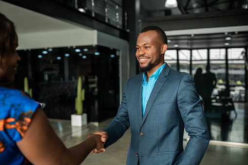 Business people, handshake and man with senior woman in office welcome, thank you or b2b deal. Job interview, success and elderly hr lady and businessman shaking hands  for onboarding or recruitment