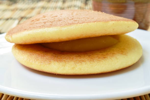 istock Dorayaki Japanese pancake stuffed sweet mashed bean eat with tea cup 1207278108
