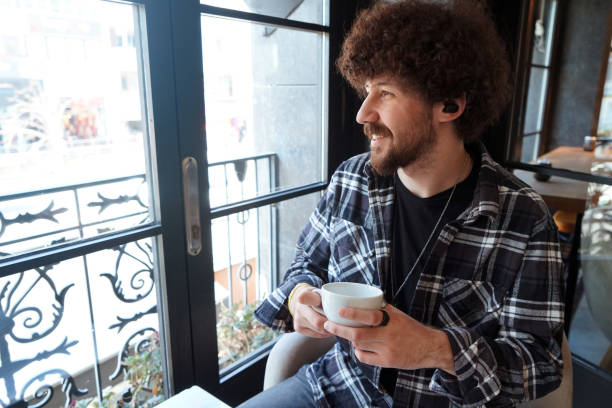 istock young men is drinking a cup of coffee 1207279354