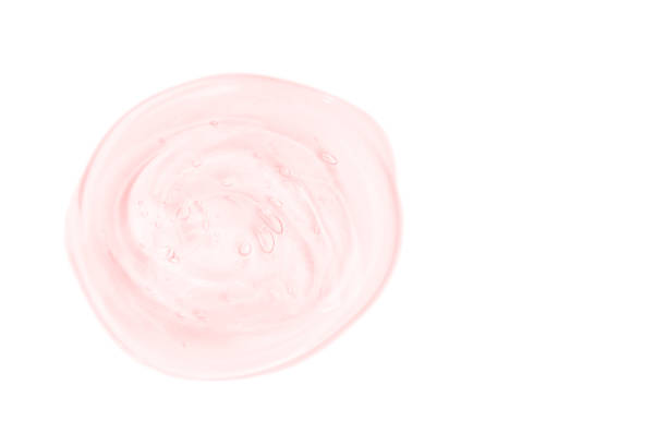 istock Clear pink liquid gel drop or smear isolated on white background. Copy space. 1207279492