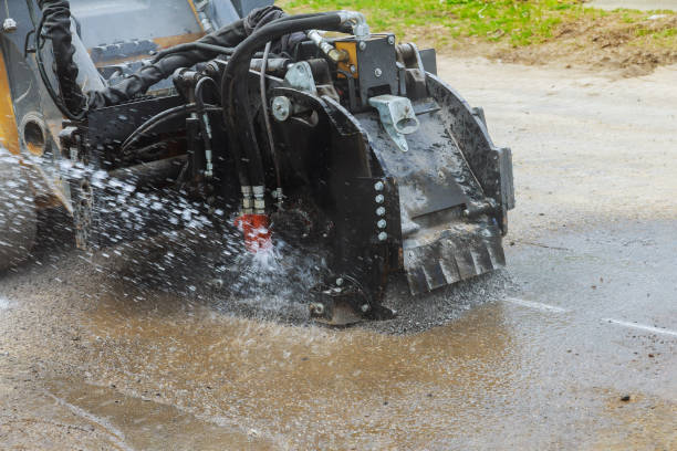 istock Roadworks scraping road machine removes old asphalt during construction 1207280352