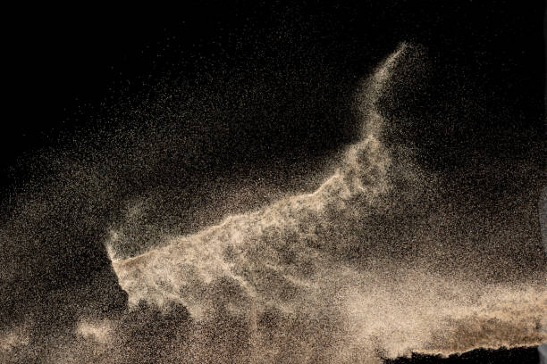 istock Brown colored sand splash.Dry river sand explosion isolated on black background. Abstract sand cloud. 1207280928