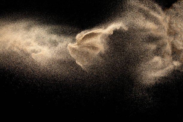 istock Brown colored sand splash.Dry river sand explosion isolated on black background. Abstract sand cloud. 1207280929