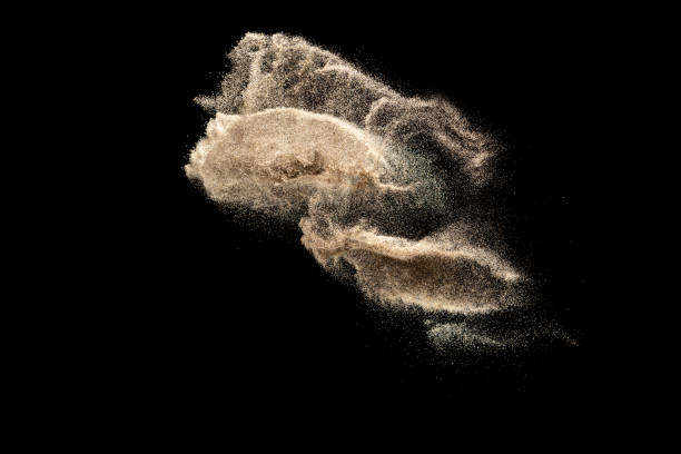 istock Brown colored sand splash.Dry river sand explosion isolated on black background. Abstract sand cloud. 1207280935
