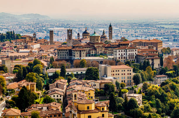 Panoramic veiw on Upper old city (Citta Alta) in Bergamo with historic buildings. Old town of Bergamo, Italy seen from hill above. bergamo stock pictures, royalty-free photos & images