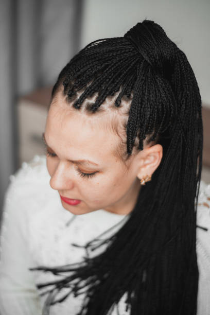 istock Beautiful girl with black Afro-pigtails on a plain background 1207283103