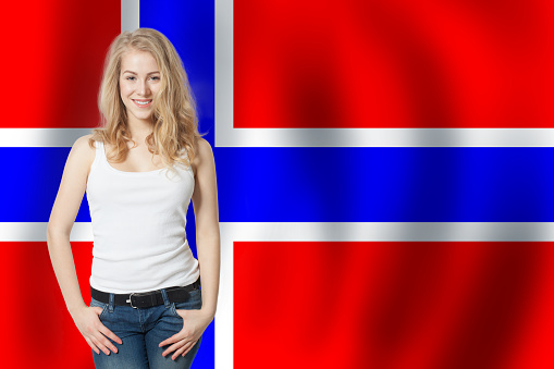 Cheerful blonde woman with Norway flag background. Live, work, education and internship in Norway