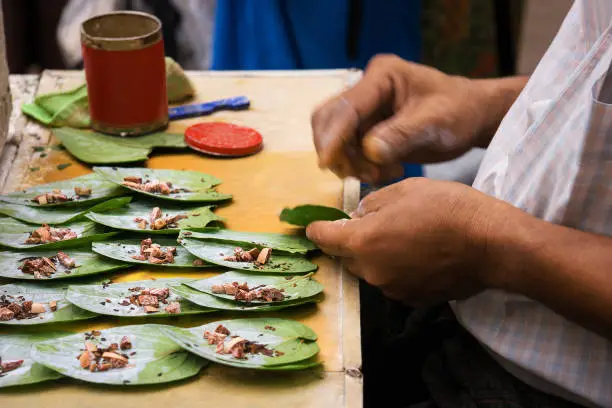 Man preparing betel chew in Myanmar. Betel quid or Paan is a combination of betel leaf, areca nut and "Kapor Sireh".