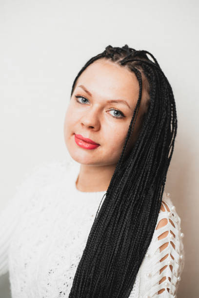 istock Beautiful girl with black Afro-pigtails on a plain background 1207285601
