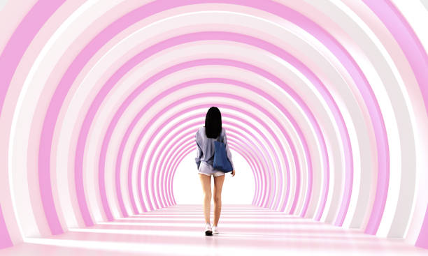 Young woman walking on pink tunnel corridor