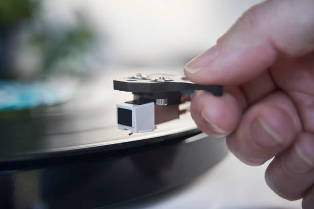 Close Up Of Hand Putting Needle Of Record Player Turntable On Vinyl LP Close Up Of Hand Putting Needle Of Record Player Turntable On Vinyl LP record player needle stock pictures, royalty-free photos & images