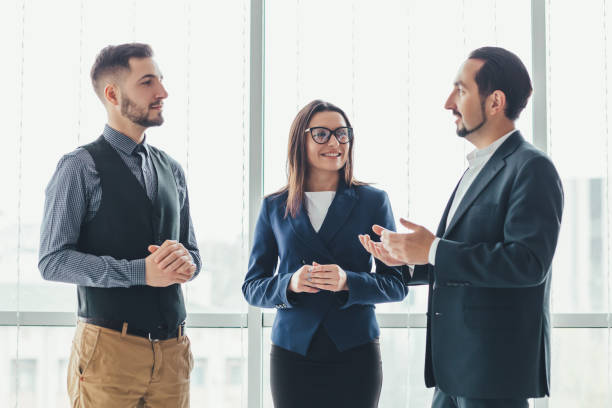 istock Three successful business people talking in office. 1207287913