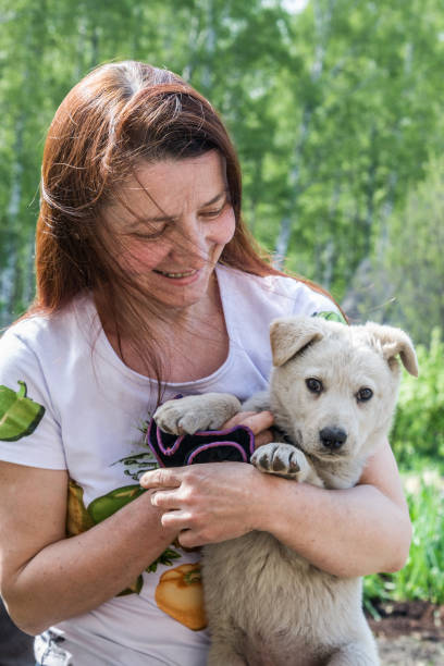 istock Woman and puppy 1207288536