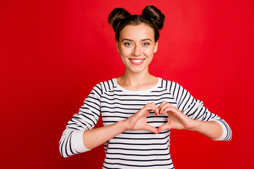 Portrait of positive cheerful girl make hart fingers her passionate love sign, wear casual style white clothes isolated over bright color background