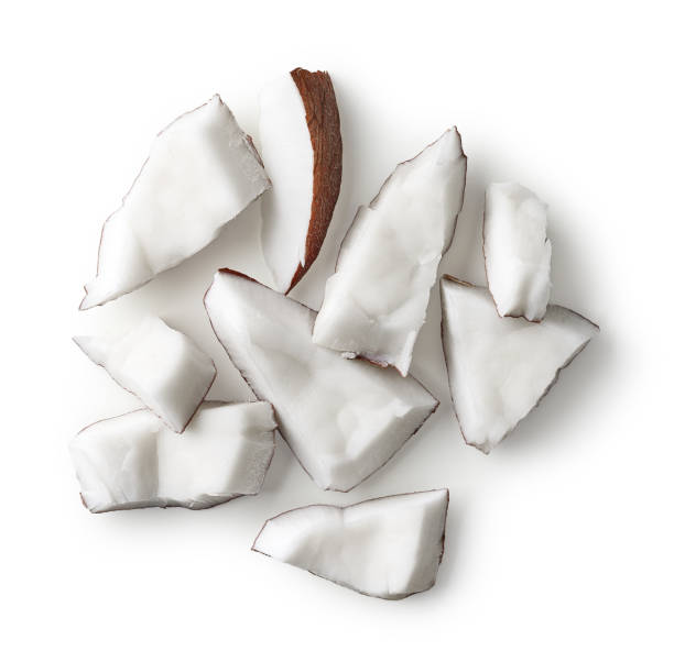 istock Heap of coconut pieces isolated on white background 1207288908