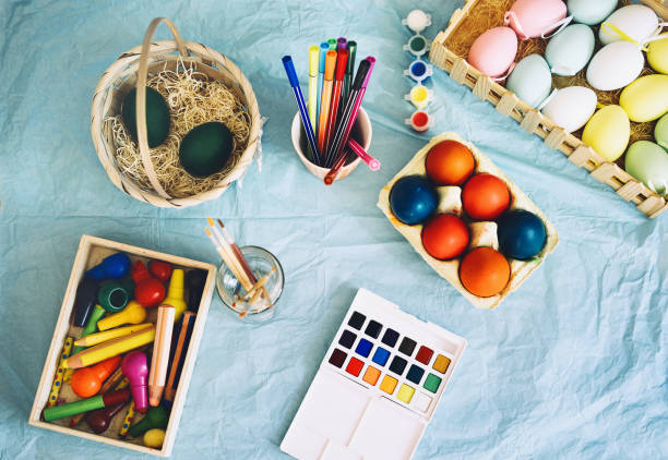 istock Happy Easter! Painting eggs. Paints, felt-tip pens, decorations for coloring eggs for holiday. Creative background. 1207290209