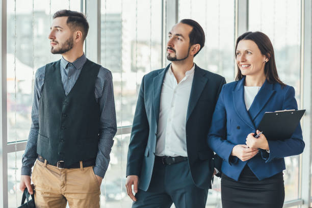 istock Happy business people standing side by side, smiling, enjoying time in such a team. 1207290328
